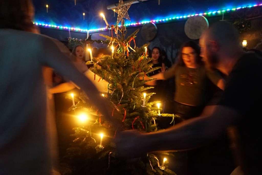 A group of people around a christmas tree